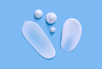 cosmetic smears cream texture on blue background
