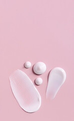 cosmetic smears cream texture on pastel pink background