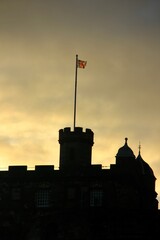 Edinburgh Castle at sunrise with the Union Jack flag in Scotland