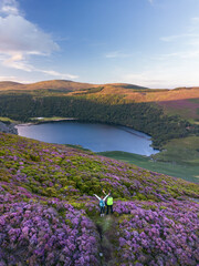 aerial photo of mountaineering couple at lough tay lake in wicklow ireland in spring