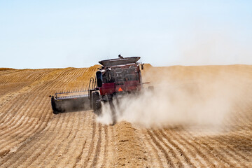 harvesting crops on palouse washington wheat fields in summer