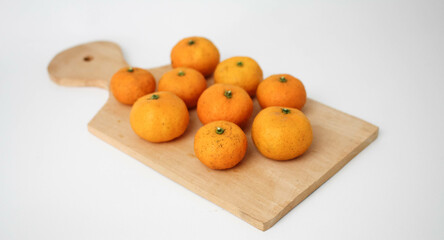 Orange Fruits on Wooden Board in White Background