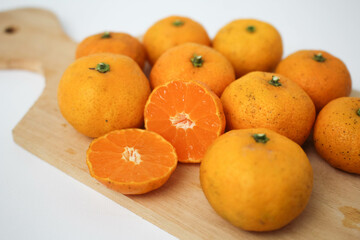 Fresh Orange Fruits Served on Wooden Board 
