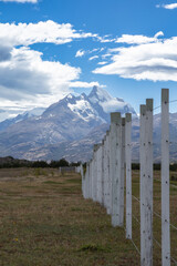 Fototapeta na wymiar Landscape with a fence and snow covered mountains. Argentina.