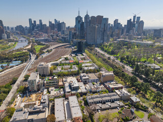 Aerial view of railway lines and high rise buildings surrounding a city block of apartment buildings