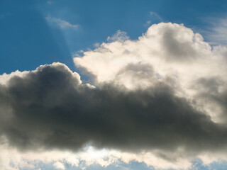 Overcast gray clouds against a sky in bright sunlight