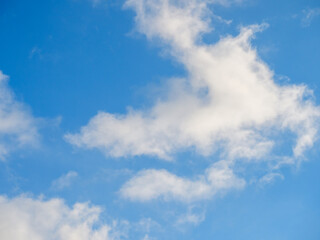 White light soft clouds against a blue sky