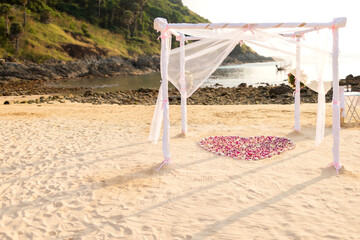 wedding set up on the sandy beach There are flowers decorated all around, beautiful and outstanding. There was a shadow cast on the ground.