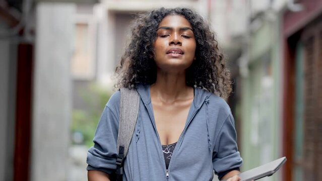 african business woman having lifr style at outdoor pedestrian space. woman in relaxing holding laptop. girl walking in relaxing and happy.