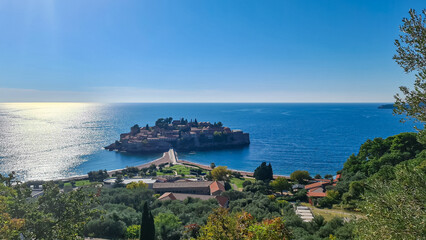 Panoramic aerial view on old historical town on the island of Sveti Stefan along the Budva coastline, Adriatic Mediterranean Sea, Montenegro, Europe. Touristic vacation travel destination. Seascape