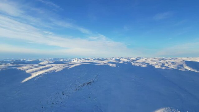 A beautiful view of snowy mountains in Norway. Panoramic view of mountain peaks 1100 meters above sea level. A clear blue sky on a cold winter day.