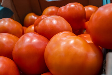 close-up red tomatoes are sold in a shopping center in the department of vegetables and fruits