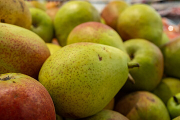 ripe pears are sold in the shopping center in the department of vegetables and fruits