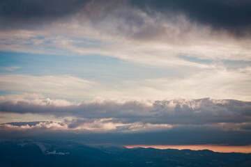 Picturesque cloudscape at highland landscape photo. Beautiful nature scenery photography with sunset on background. Idyllic scene. High quality picture for wallpaper, travel blog, magazine, article