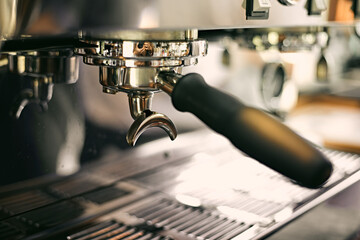 Close up of coffee machine pouring espresso in cafe,