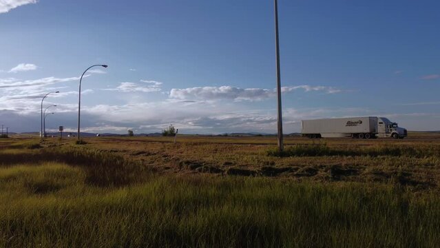 Highway with truck approached at low angle grass