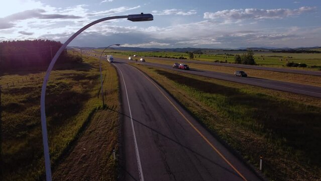 Semi truck by highway approached sun flare