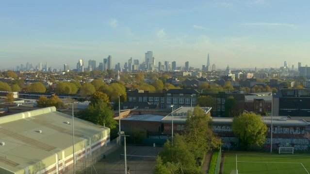 Descending aerial shot of London skyline into north london suburbs