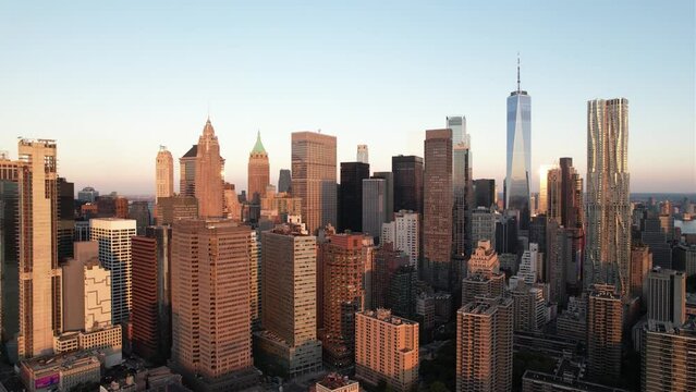 Sunlit skyscrapers in the Financial District of Manhattan, golden hour in New York - Aerial view