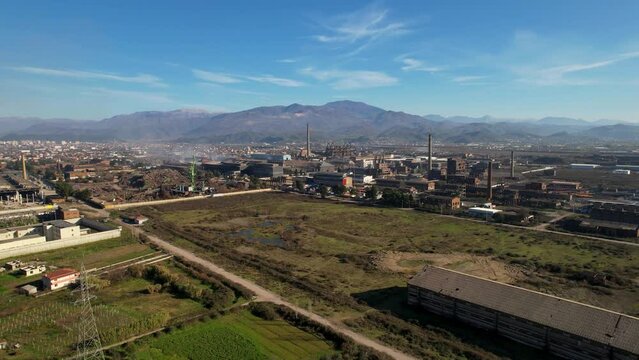 Smoke rising from the chimneys of the furnaces on metallurgic factory industrial zone in Elbasan, Albania