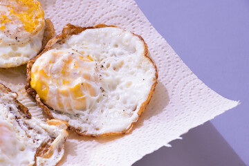 Sunny side up eggs, salted and served hot, somewhat over easy style