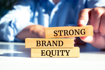 Wooden blocks with words 'Strong brand equity'. Business concept