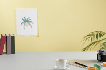 casual office desk with bright yellow background