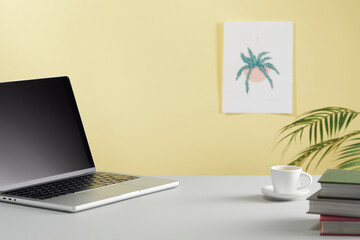 casual office desk with bright yellow background