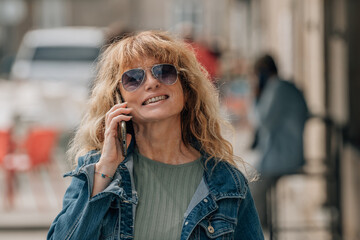 adult woman with smartphone on the street