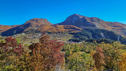 Panoramic view on mountain peaks Golis, Stirovnik and Gomile in Lovcen, Orjen national park, Dinaric Alps, Montenegro, Balkan Peninsula, Europe. Idyllic hiking trail on sunny golden colored autumn day