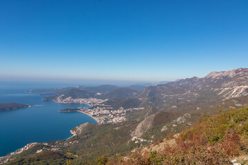 Panoramic aerial view on the coastline of Budva and Sveti Nikola Island seen from Goli Vrh, Adriatic Mediterranean Sea, Montenegro, Balkan, Europe. Luxury hotel resorts along Budvanian Riviera.