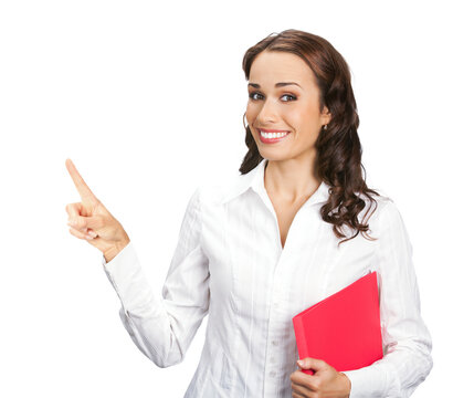 Portrait image of smiling business woman with red folder showing, pointing, advertising something or copyspace area, isolated white background. Businesswoman, office worker, teacher, real estate agent