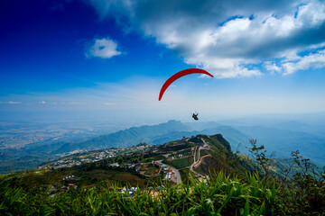 Paragliding concept, paraglider pilot fly in sky on beauty nature mountain landscape,Phu Thap...