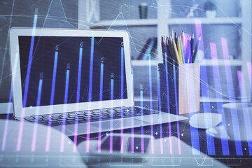 Stock market graph and table with computer background. Double exposure. Concept of financial analysis.