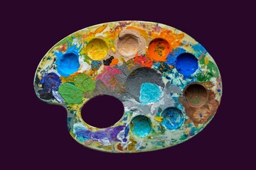 Oval art palette with paints .