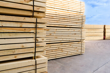 Piles of  Mixed wood  Pine wood  in the sawmill, planking. Warehouse for sawing boards on a sawmill outdoors. Wood timber stack of wooden blanks construction material Industry.
