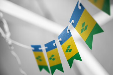 A garland of Saint Vincent national flags on an abstract blurred background
