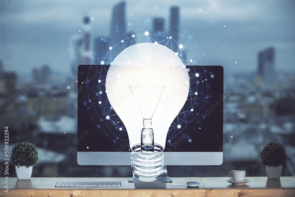 Poster computer on desktop in office with bulb icon hologram. multi exposure. concept of idea.