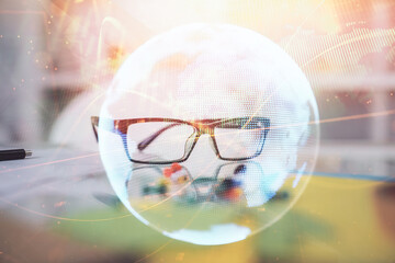 Business theme hologram with glasses on the table background. Concept of search. Double exposure.