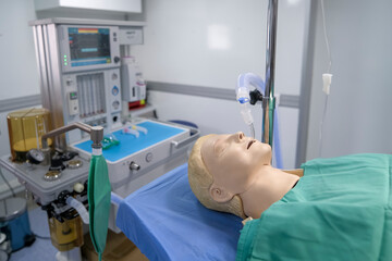 Medical patient simulator in the operating room of a hospital emergency room. Equipment and medical...