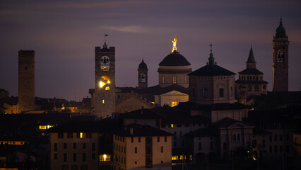 Naklejka premium Bergamo. One of the beautiful city in Italy. Landscape at the old town from the hill at evening. Amazing view of the towers, bell towers and main churches. Touristic destination. Best of Italy