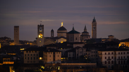 Fototapeta na wymiar Bergamo. One of the beautiful city in Italy. Landscape at the old town from the hill at evening. Amazing view of the towers, bell towers and main churches. Touristic destination. Best of Italy