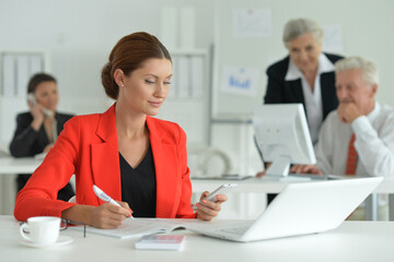 group of successful business people in office, businesswoman on foreground