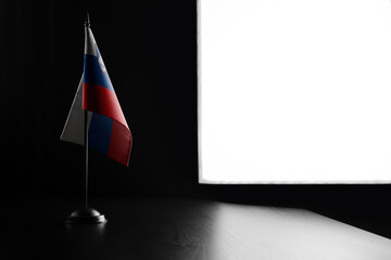 Small national flag of the Slovenia on a black background