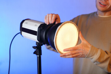 a flash with a modifier on with a diffuser with a person