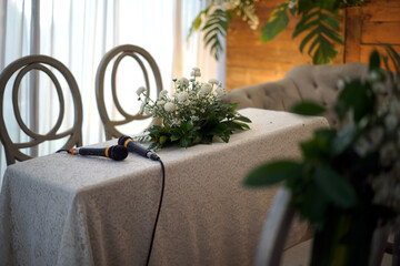 Two Microphones and Flowers on a Table for Wedding Procession