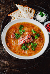 vegetables soup with meat in white bowl on table