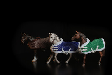 Black toy horse isolated on black background