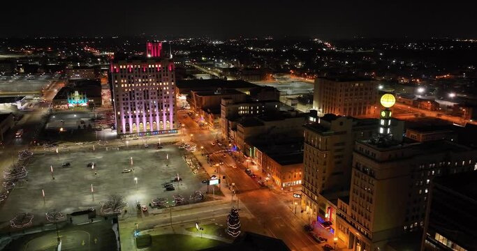 Flint, Michigan at night skyline with a wide shot of drone video circling.