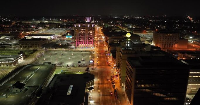 Flint, Michigan at night skyline with wide shot drone video moving forward.